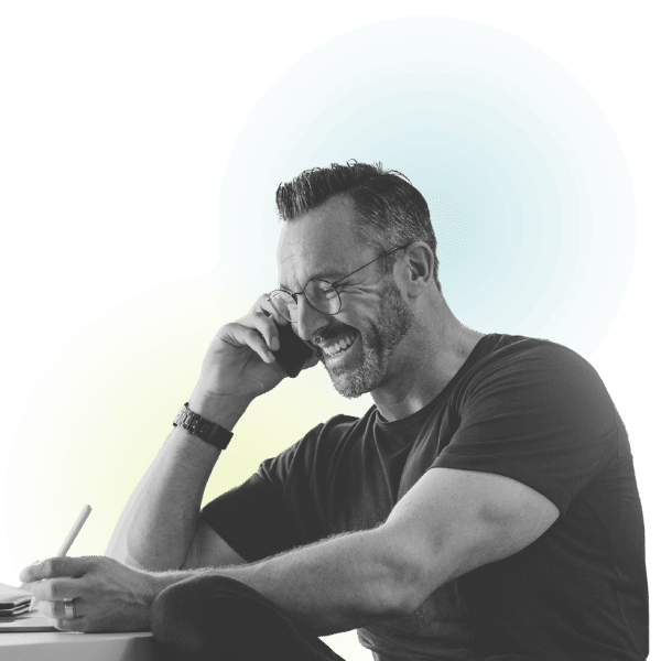 Content Marketing A customer smiling and talking on the phone while reading content written by ventralocal on his new website