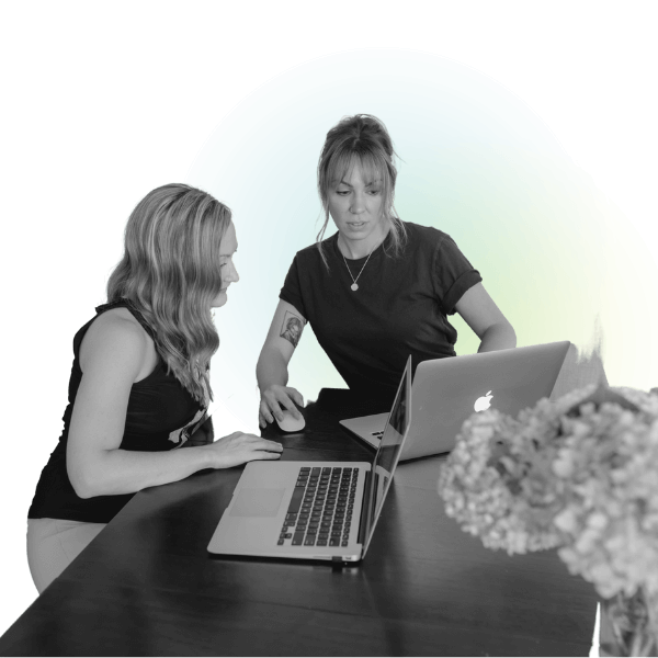 Website designers a female VentraLocal employee seated next to a client showing her their performance data for the month